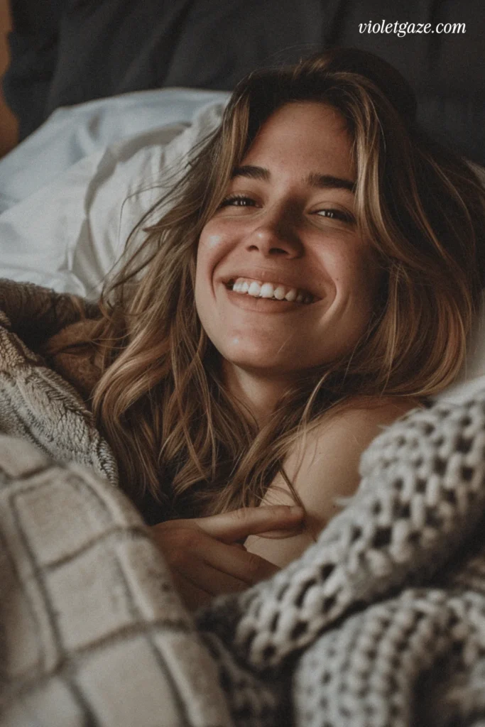 woman smiling while cozy in bed